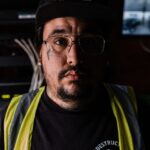 A man wearing a hat and glasses