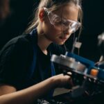 A young woman wearing safety glasses